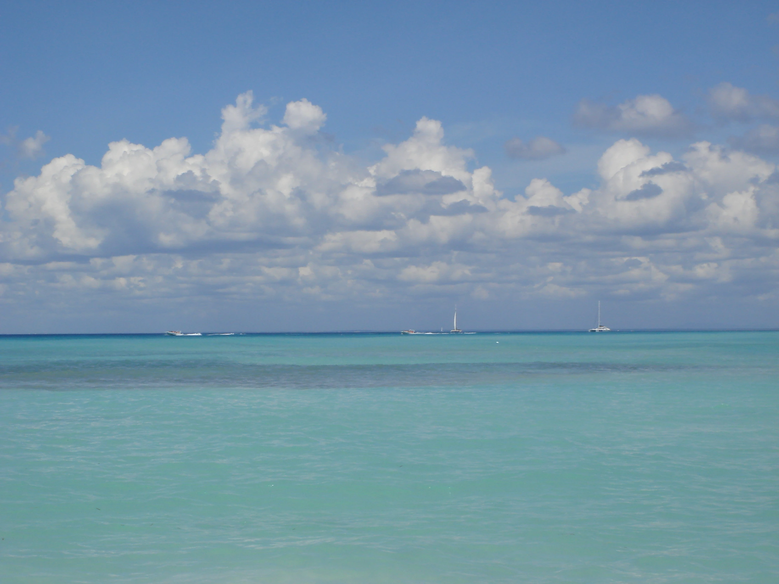 Bands of turquoise shallow water meet the blue Caribbean horizon on the Saona excursion route.